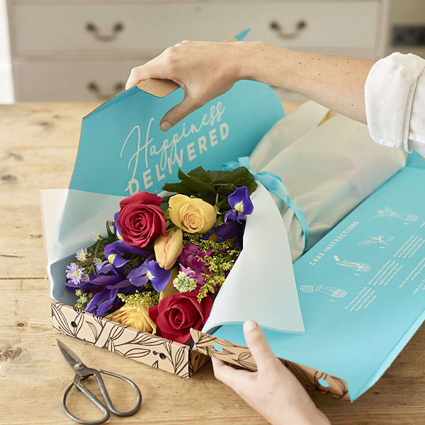 Letterbox with fresh flowers being opened